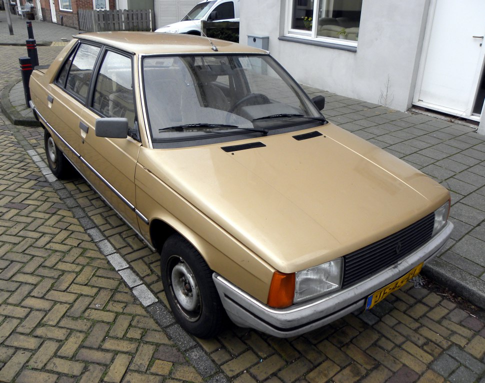Vintage sedan front view with rectangular headlights and angular hood.