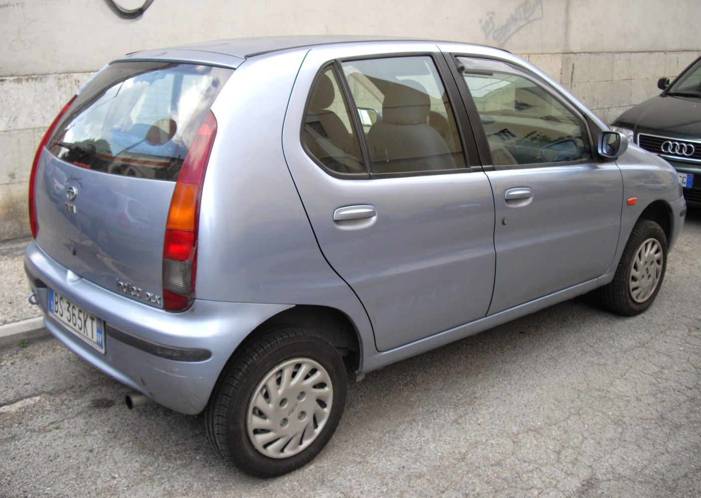 Rear side view of a hatchback with tall vertical tail lights and compact doors