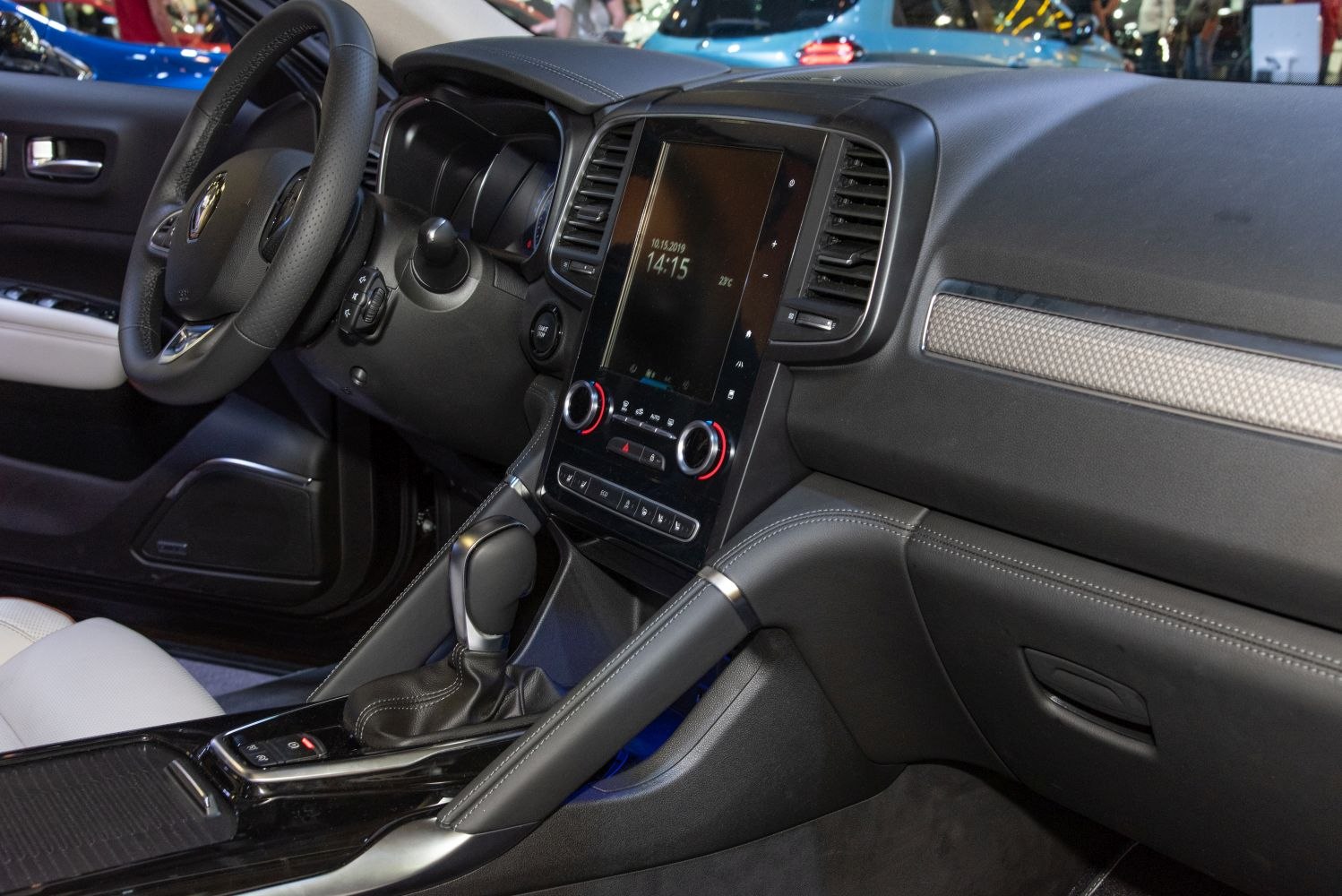 Dashboard with touchscreen, climate controls, and gear shift lever