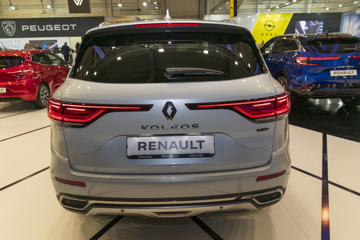 Rear view of a silver SUV with LED tail lights and dual exhaust