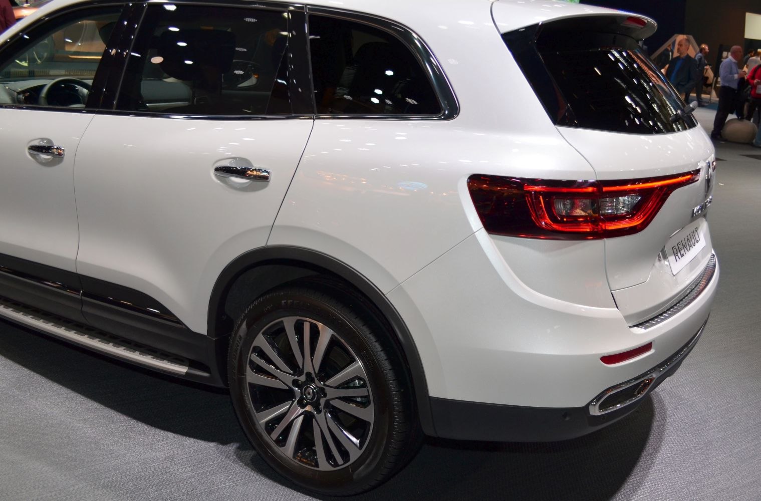Rear and side section with taillights and alloy wheel of white SUV
