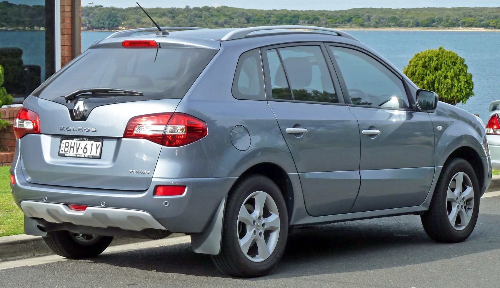 Rear side profile with tail lights, rear wiper, and alloy wheels.