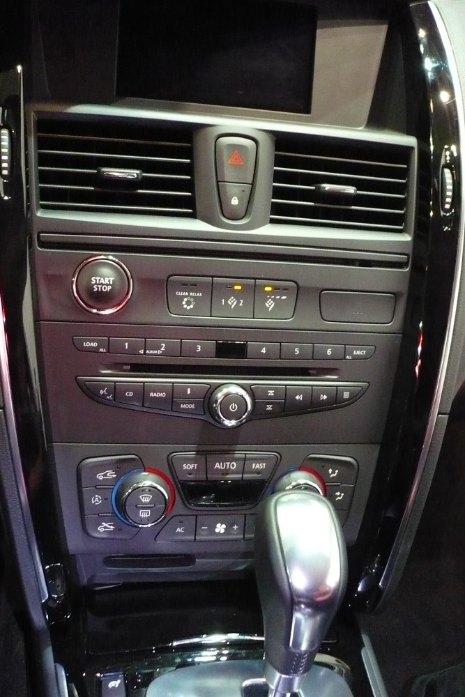 Center console with start/stop button, climate controls, audio system, and gear shift lever