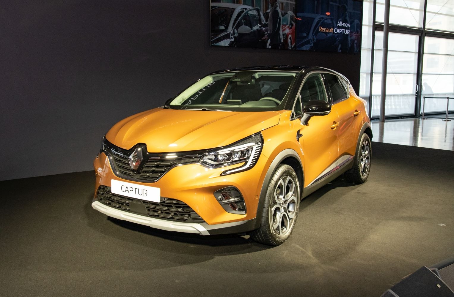Front and side view of an orange compact crossover with alloy wheels