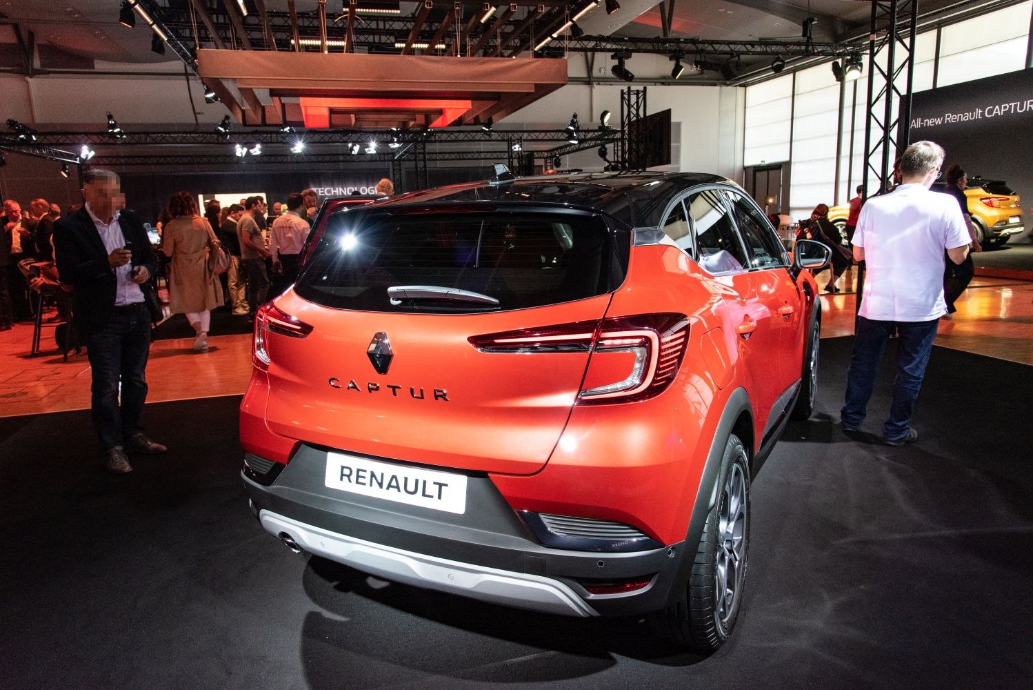 Rear view with distinct LED taillight design and vibrant orange color