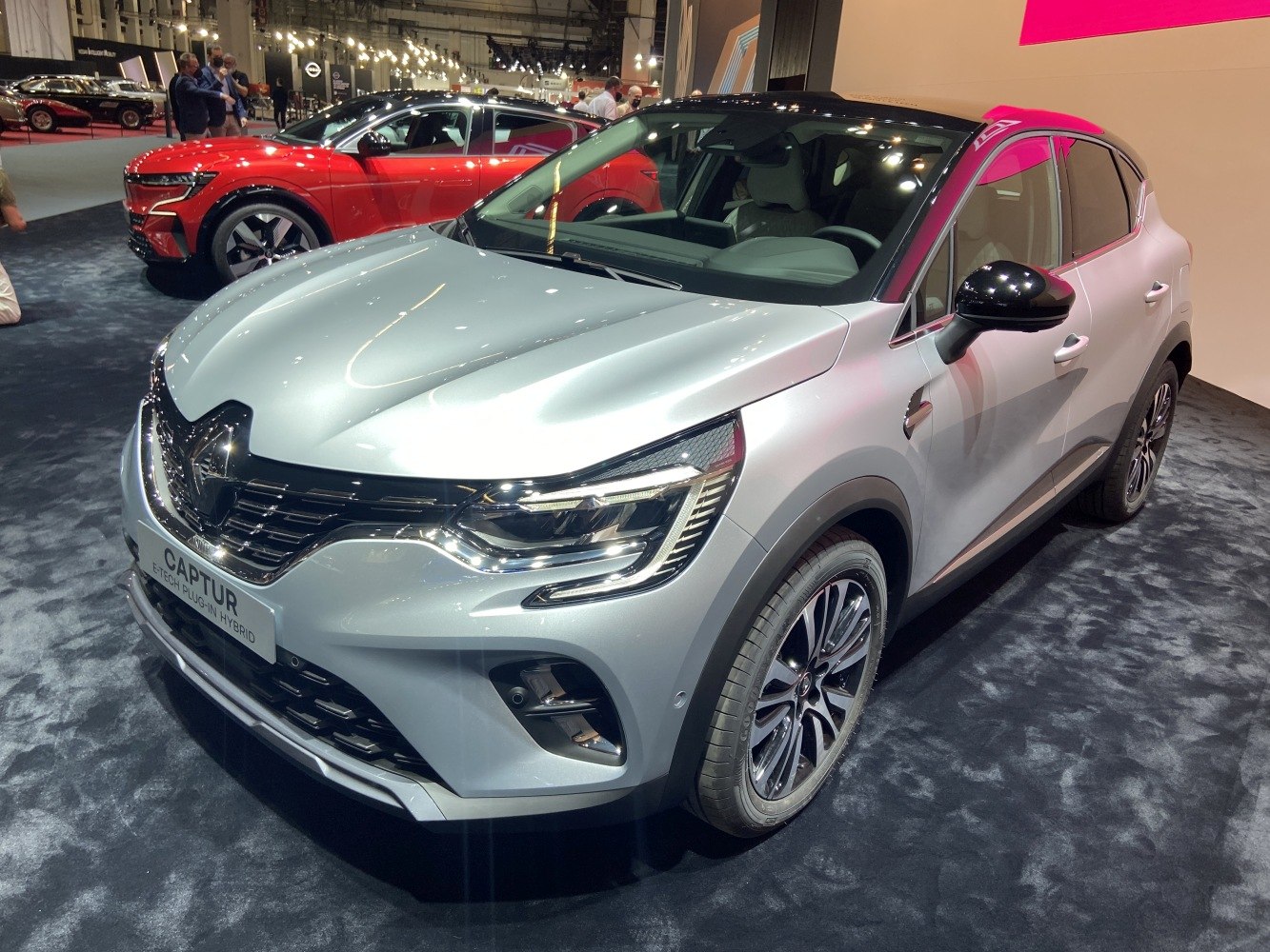 Front three-quarter view of modern SUV with sleek headlights and hybrid badge