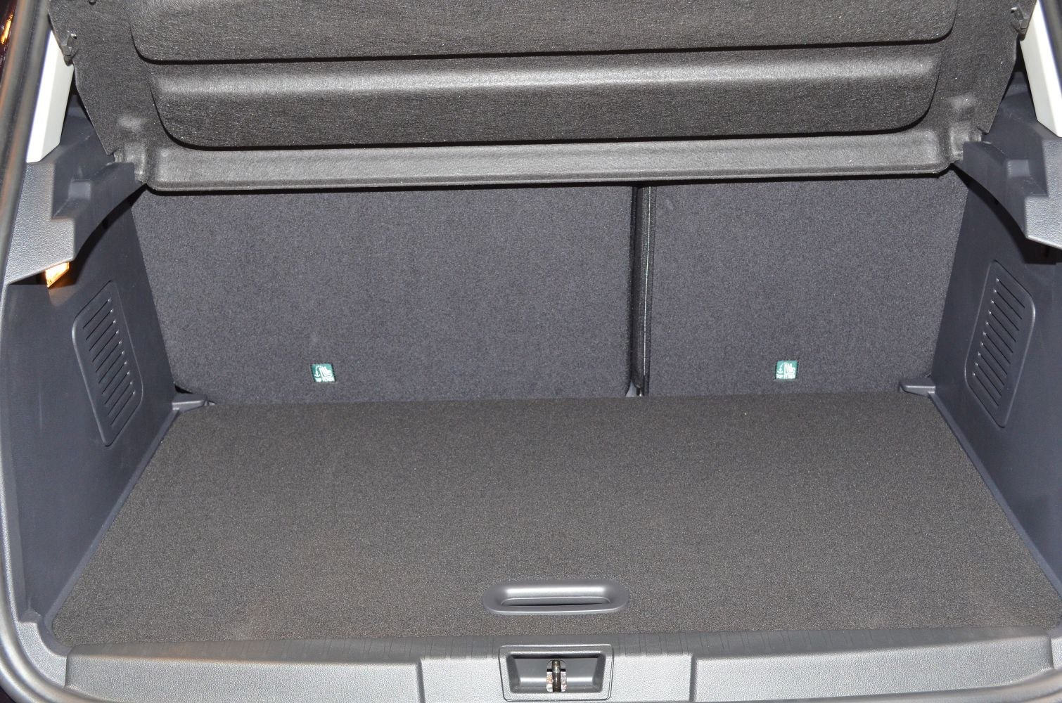 Spacious clean cargo trunk interior with foldable rear seats and textured side panels