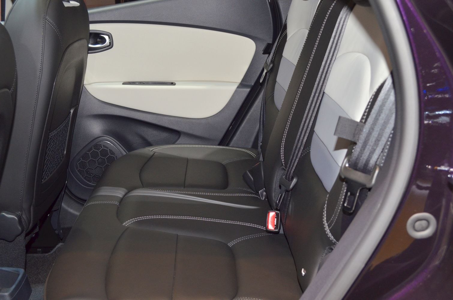 Leather rear seats with detailed stitching and door panel controls