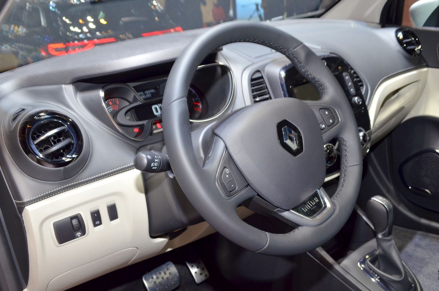 Steering wheel and dashboard with control buttons and air vents
