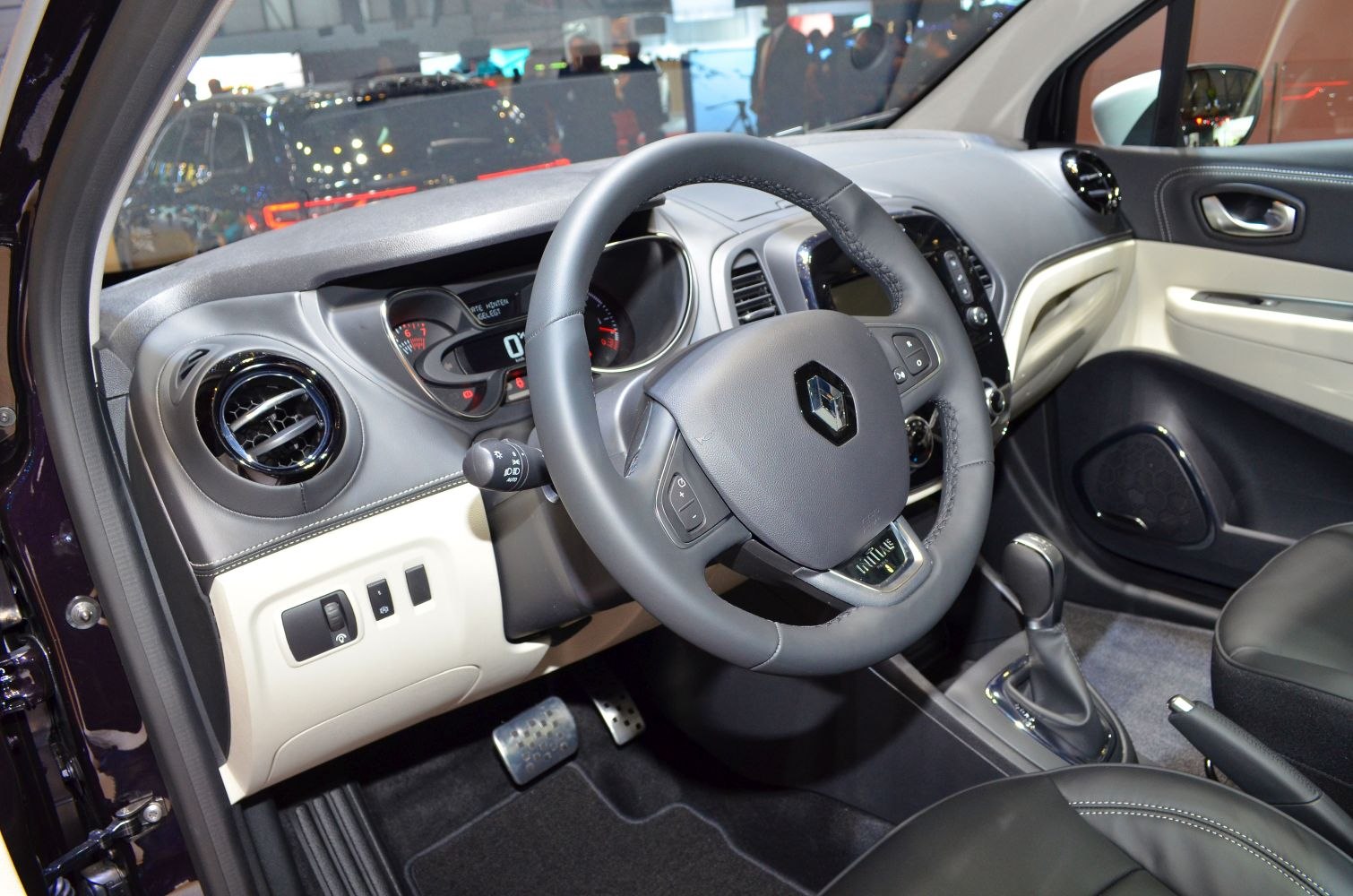 Modern car interior with dashboard and steering wheel.