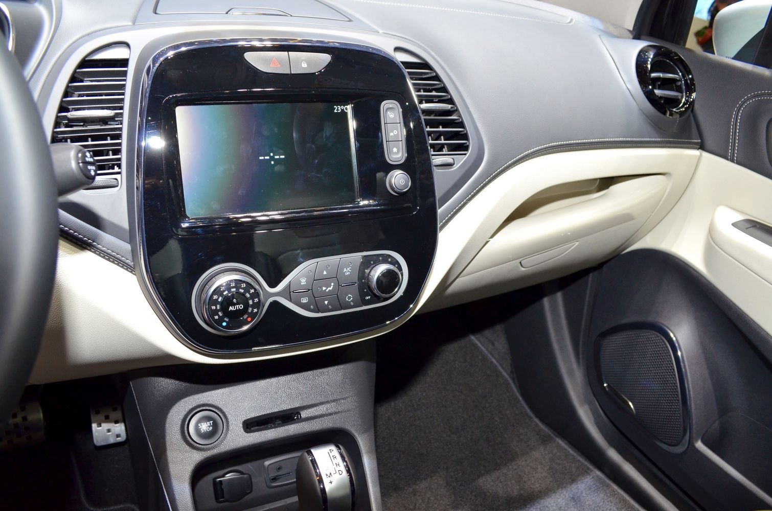 Modern car dashboard, infotainment screen, climate control panel, start/stop button
