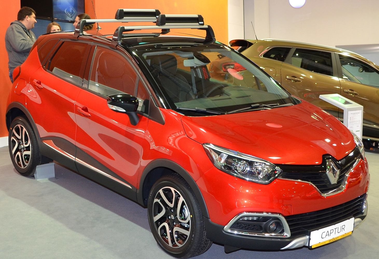 Red compact SUV with roof rack and alloy wheels