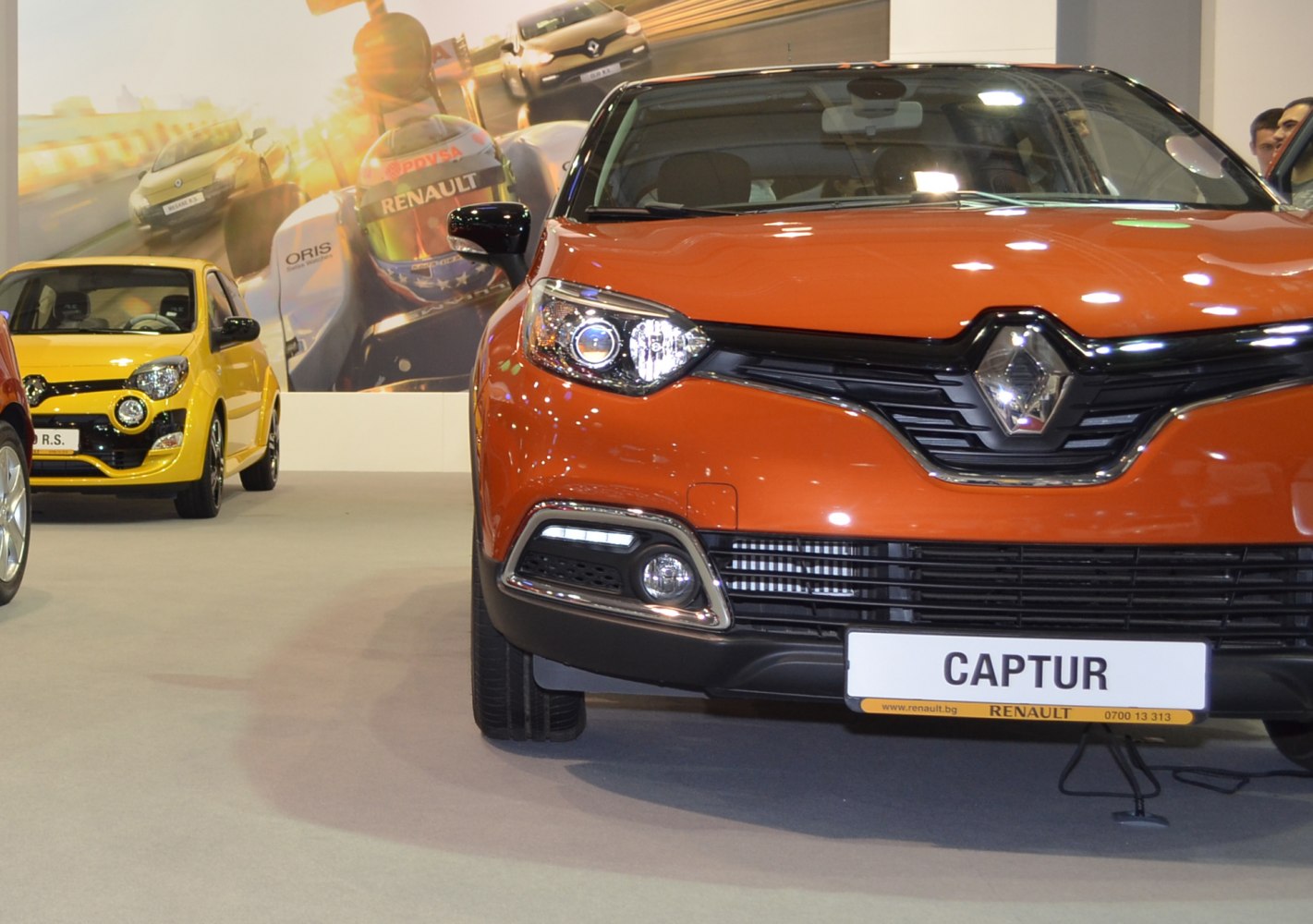 Front grille and headlights with fog lights and orange paint.