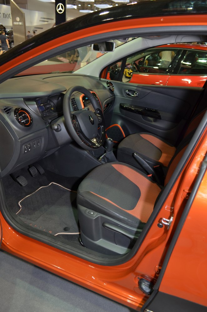 Car interior with orange-accented seats and modern dashboard layout