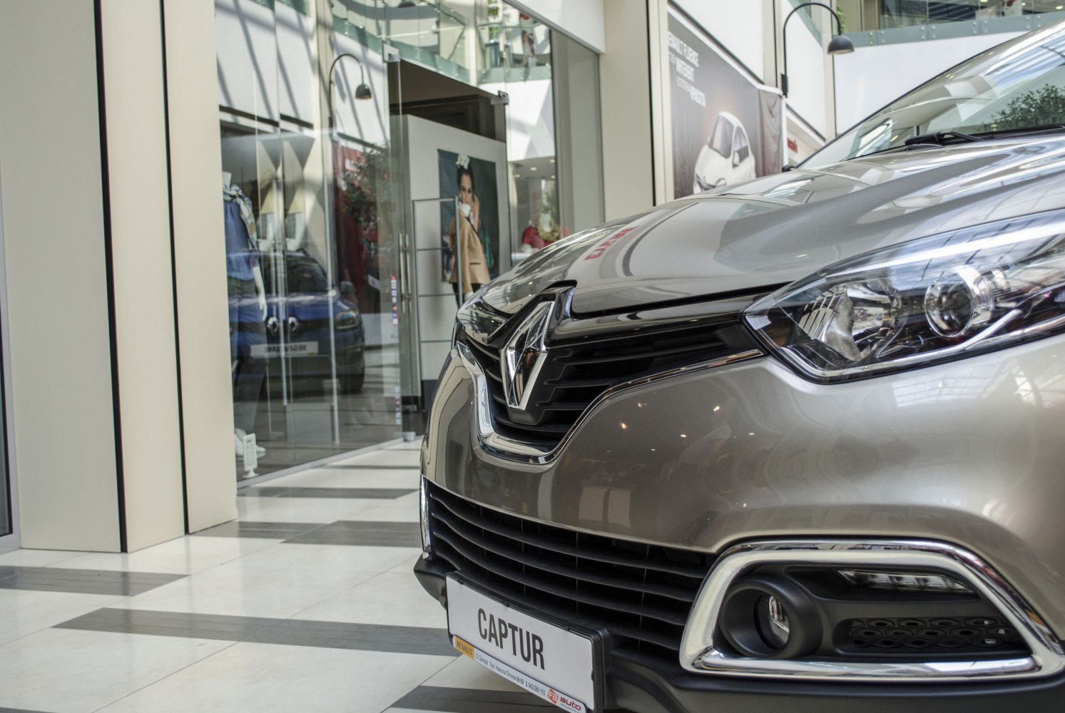 Close-up of front grille, headlight, and bumper with fog light and chrome trim