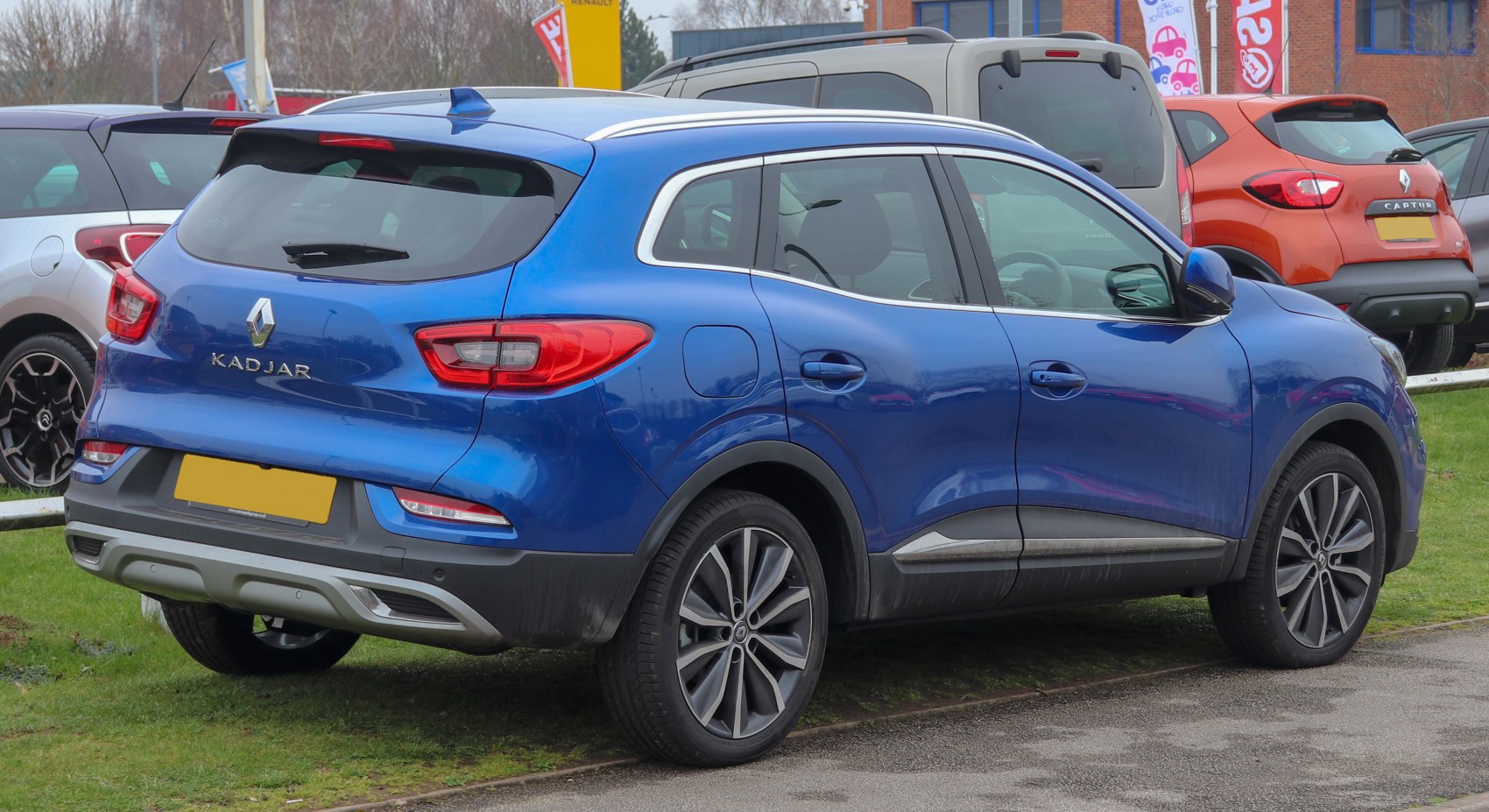 Rear exterior of a blue modern compact SUV with distinctive taillights and alloy wheels