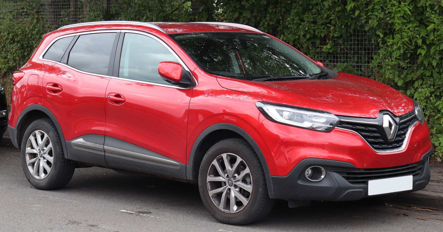Red SUV with LED headlights and alloy wheels side-front view