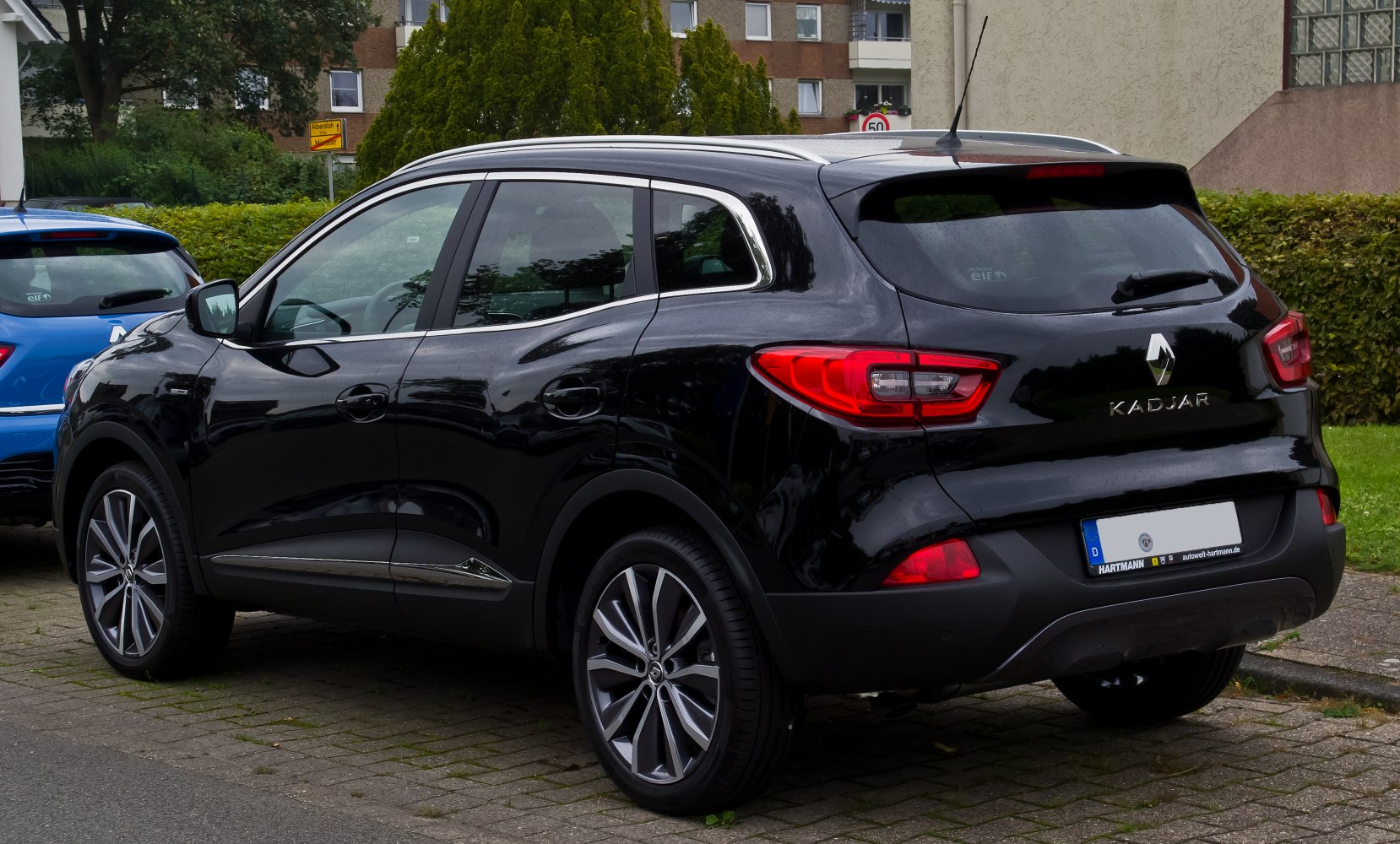 Rear side profile, taillights, alloy wheels of black SUV