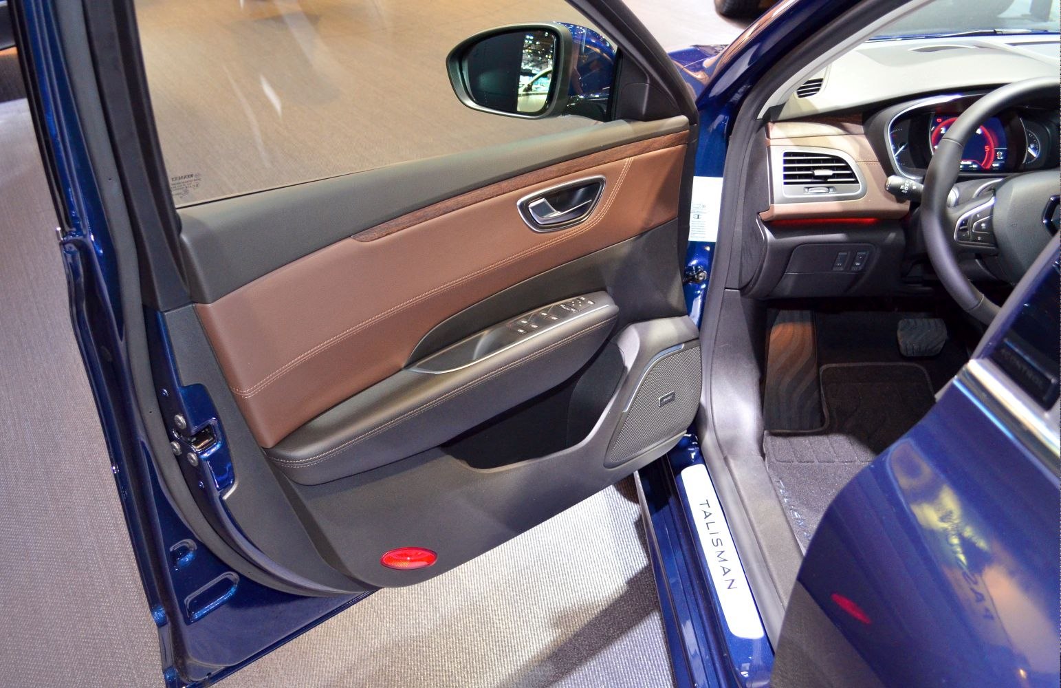Interior door panel with control buttons and speaker