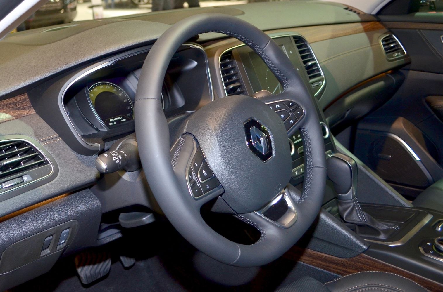 Leather steering wheel, digital dashboard, wood trim in car interior