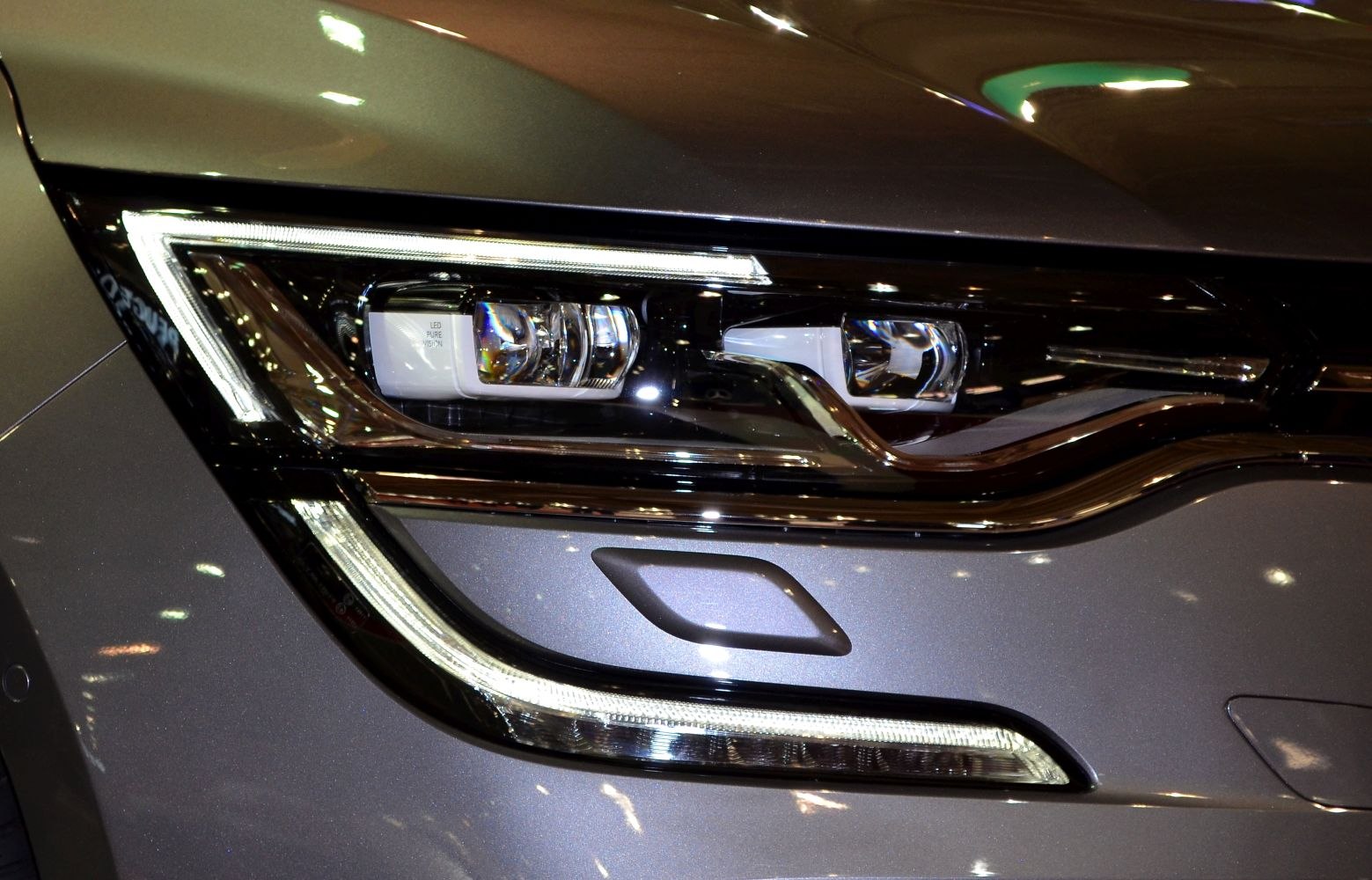 Close-up of Renault Talisman 2015 LED headlight with modern design