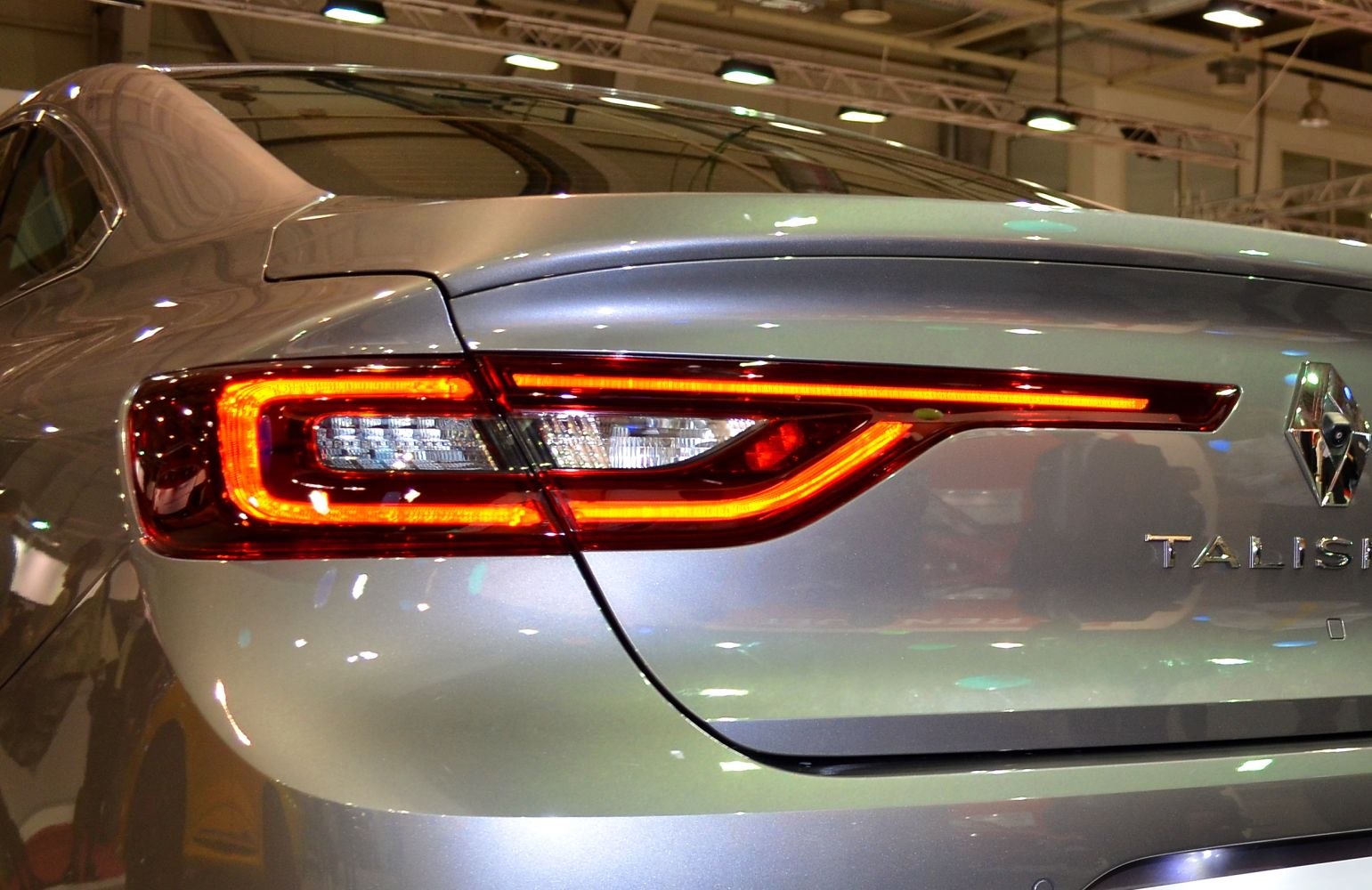 Rear LED tail light with illuminated red light strip and clear inner sections