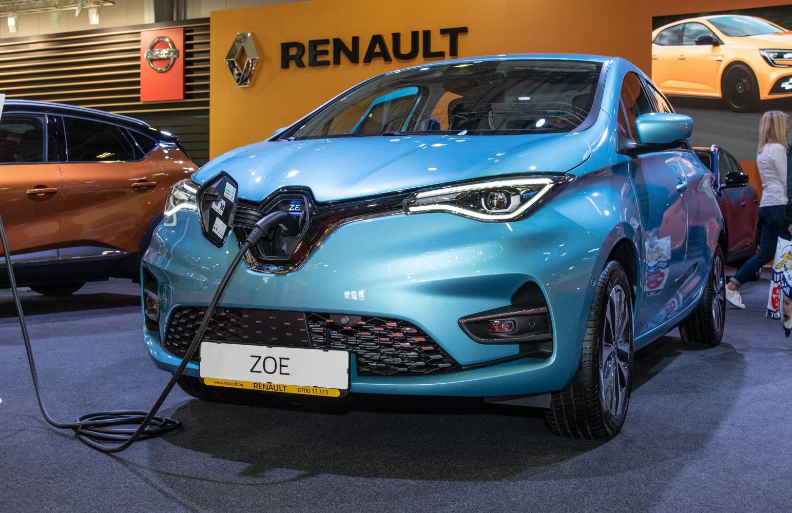 Front view of electric hatchback with charging port and modern headlights