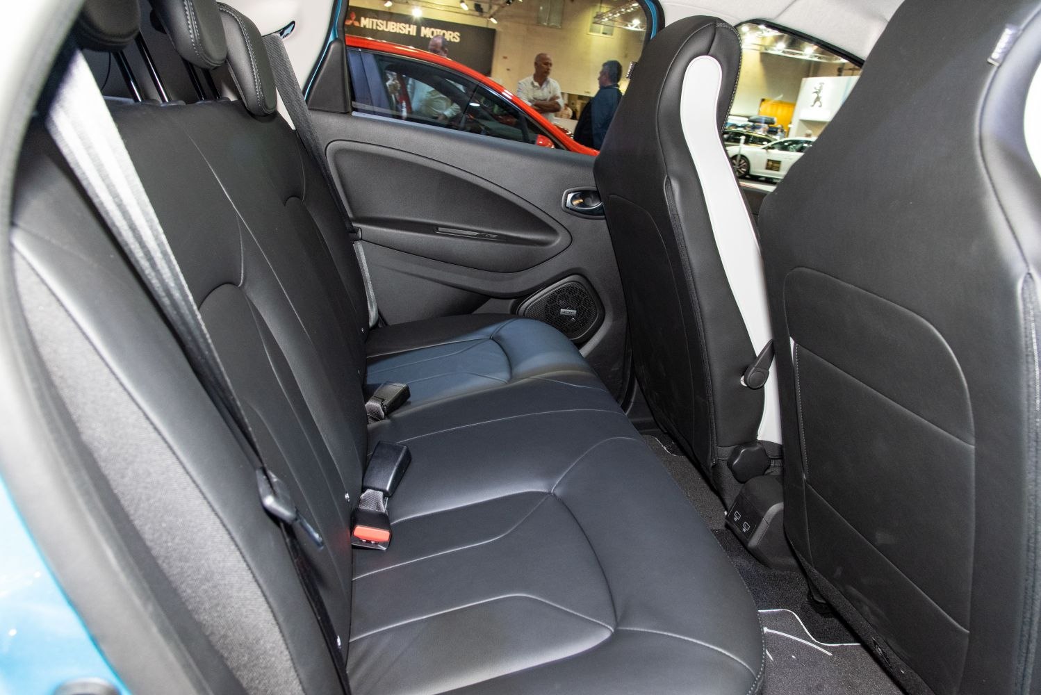 Rear seat interior with black leather upholstery and seat belts