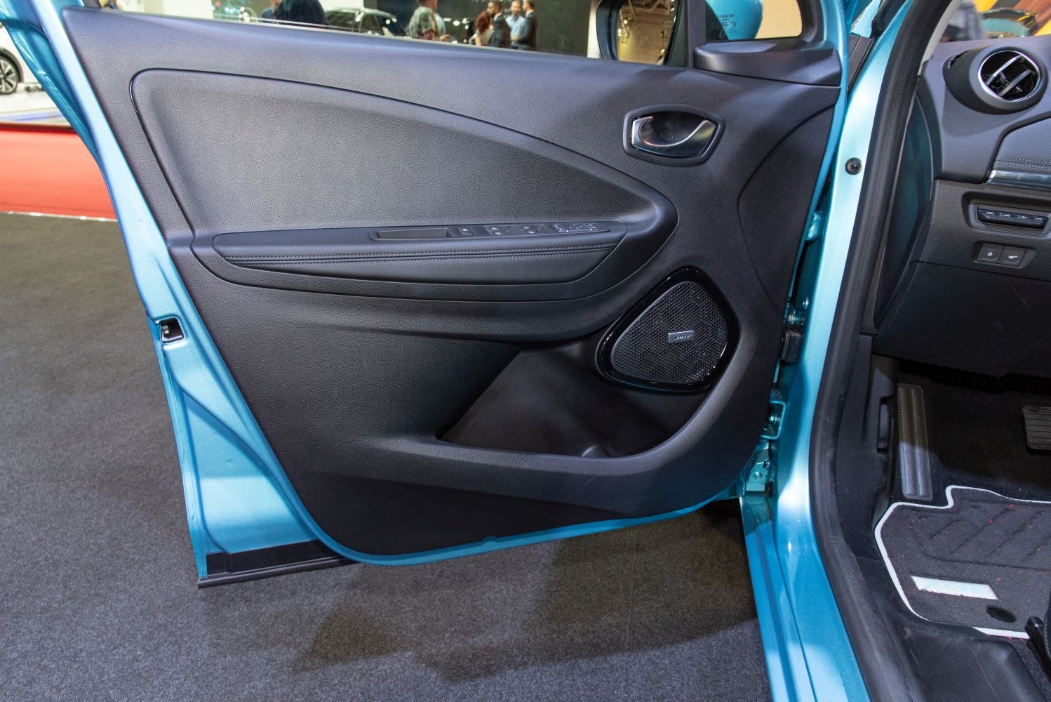 Car interior door panel with control buttons and Bose speaker