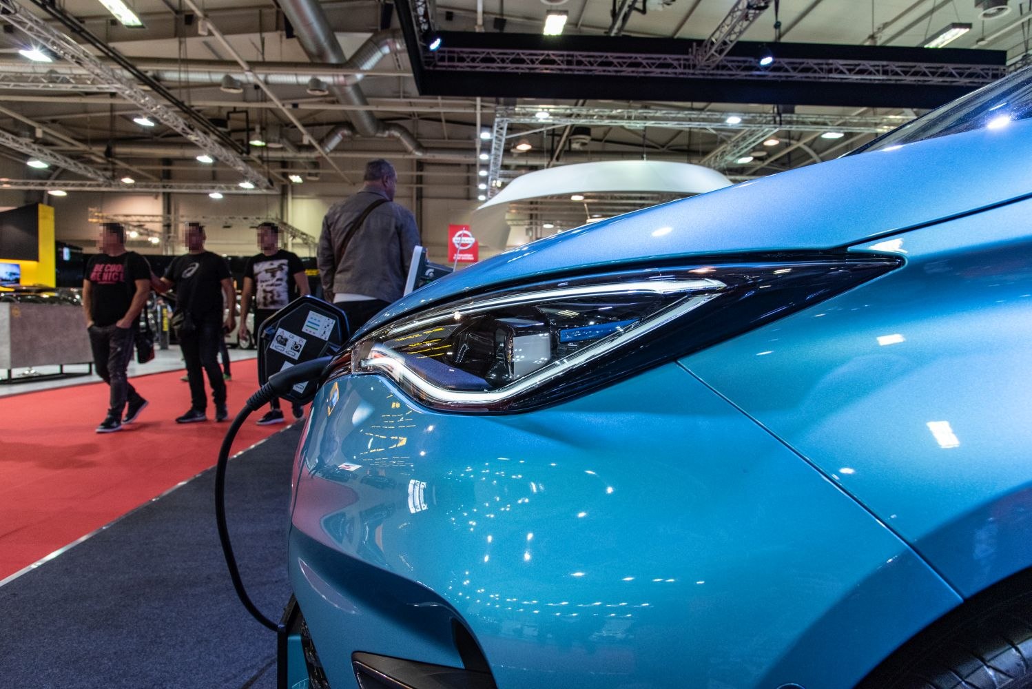 Close-up of front headlight and charging port of electric vehicle