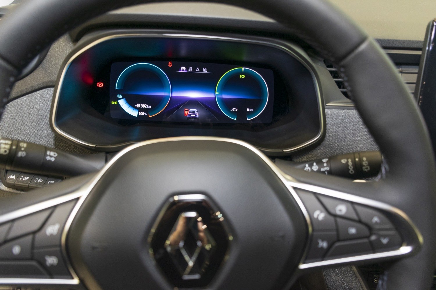 Digital instrument cluster with dual circular gauges and multifunction steering wheel controls.