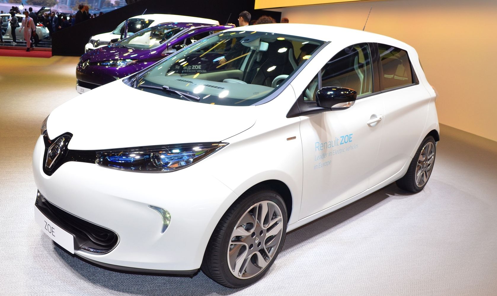 White electric hatchback with sleek headlights and alloy wheels
