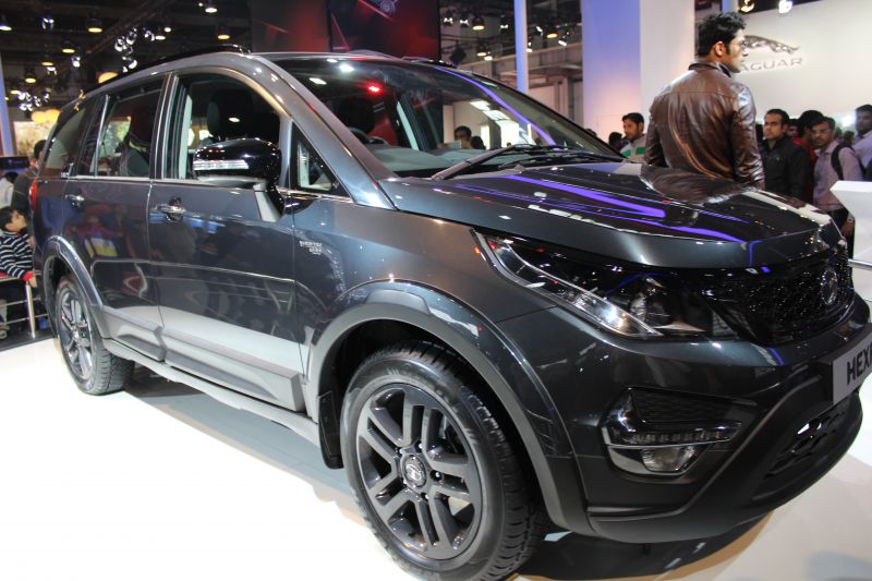 Glossy black SUV with sleek headlights and alloy wheels.