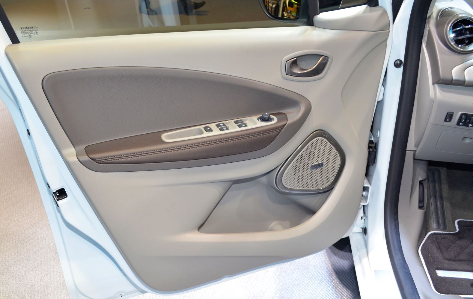 Interior door panel with window controls and Bose speaker