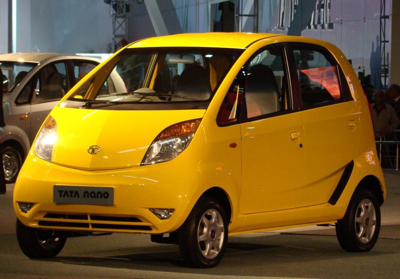 Compact yellow hatchback with unique front design and small wheels