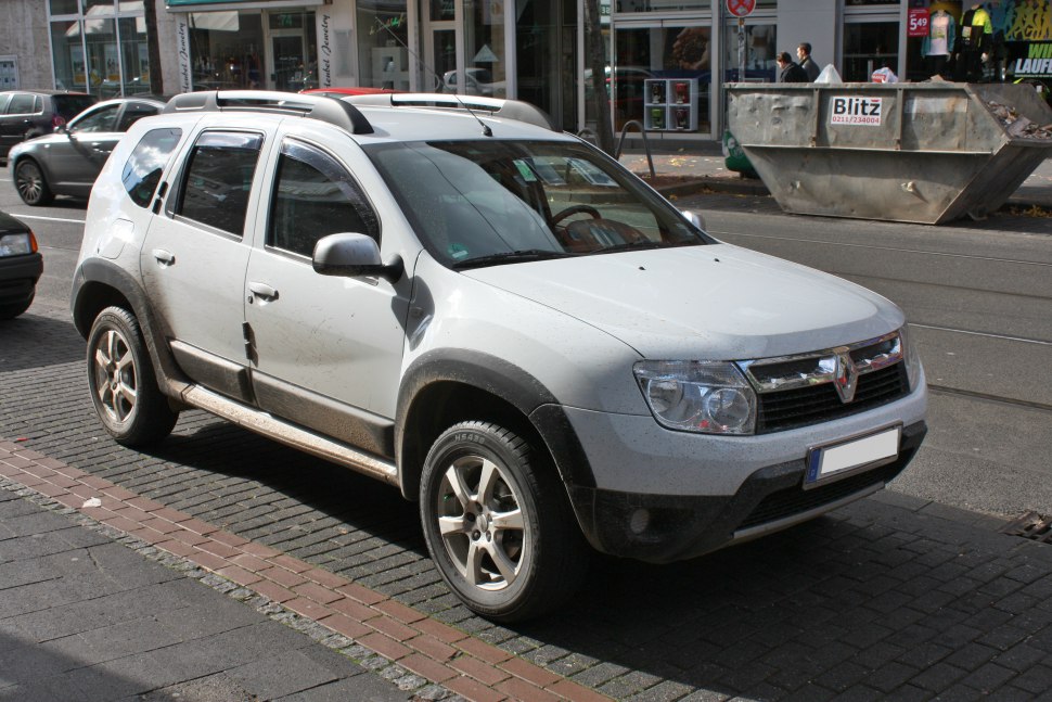 SUV with rugged exterior and roof rails parked on urban street