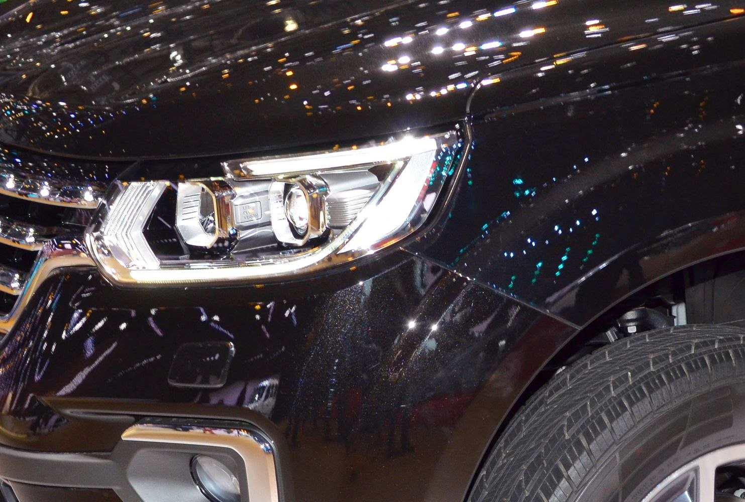 Close-up of Renault Alaskan 2017 front headlight and fender details