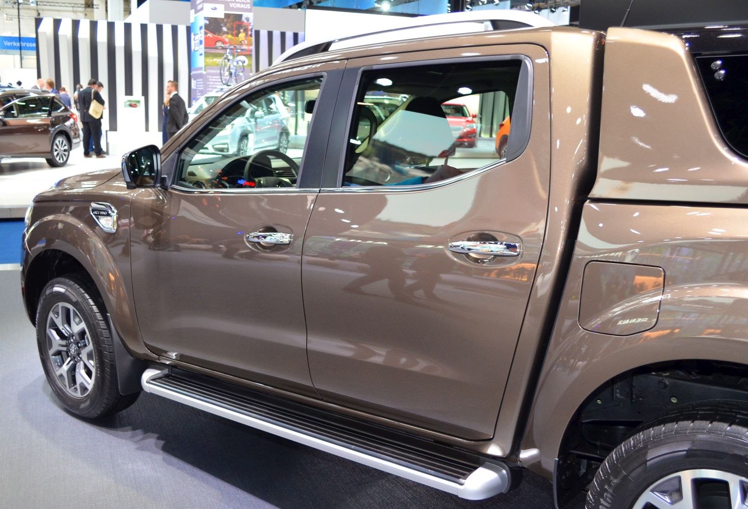 Close-up side view with door panels, chrome handles, and running board