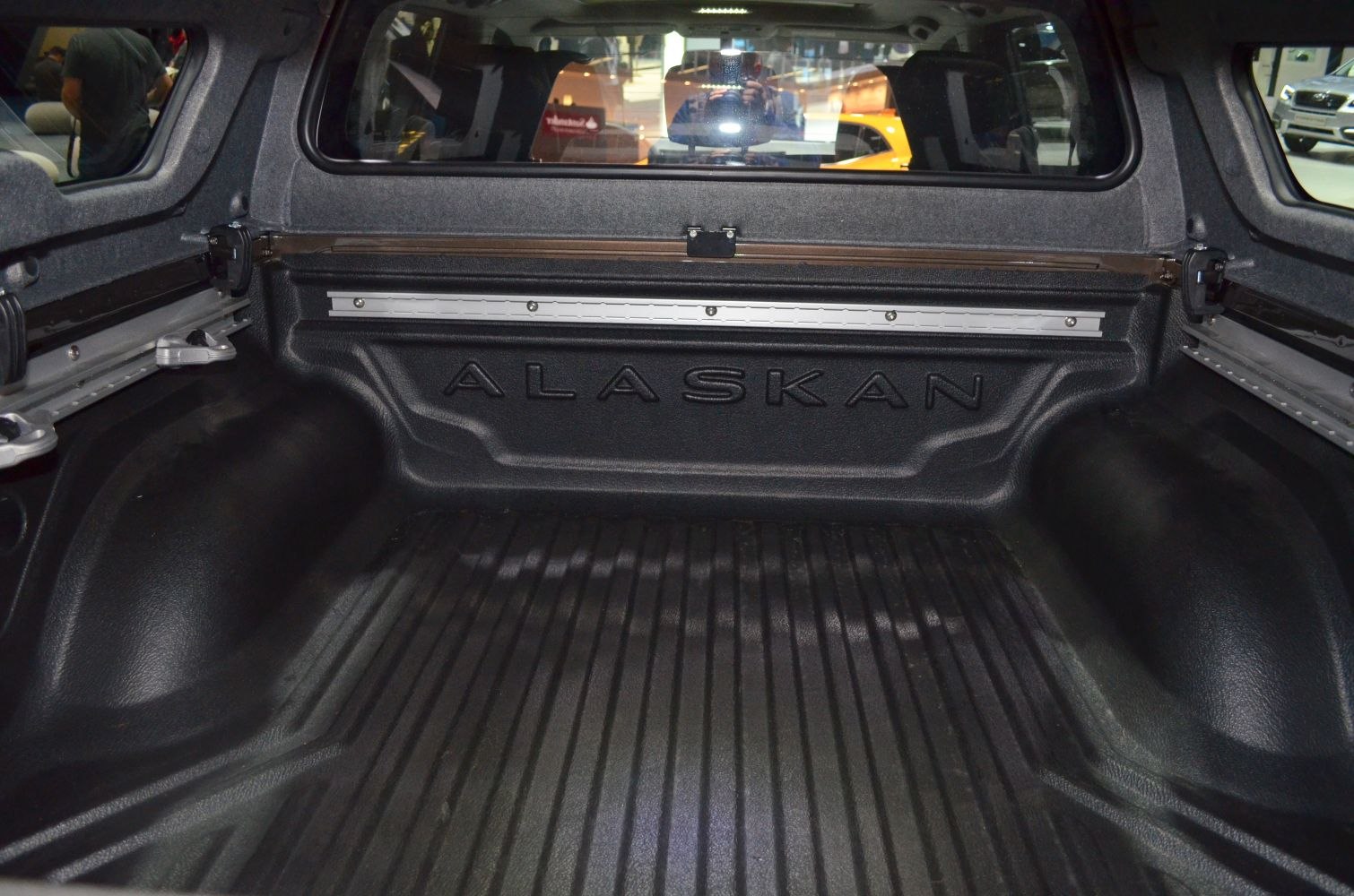 Pickup truck bed interior with protective liner and cargo anchor points
