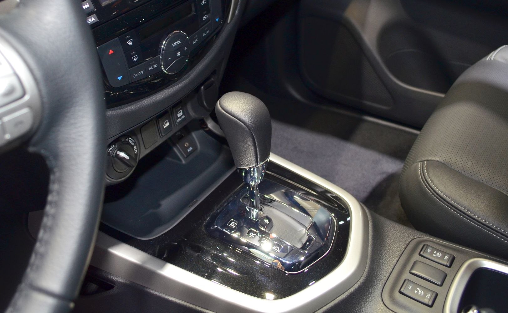 Close-up of automatic gear shift and control panel in vehicle interior