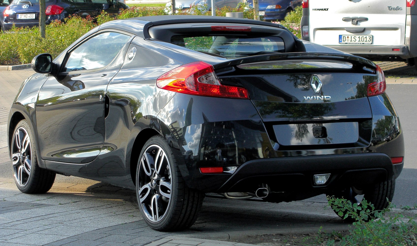 Rear view of black convertible with alloy wheels and sporty design