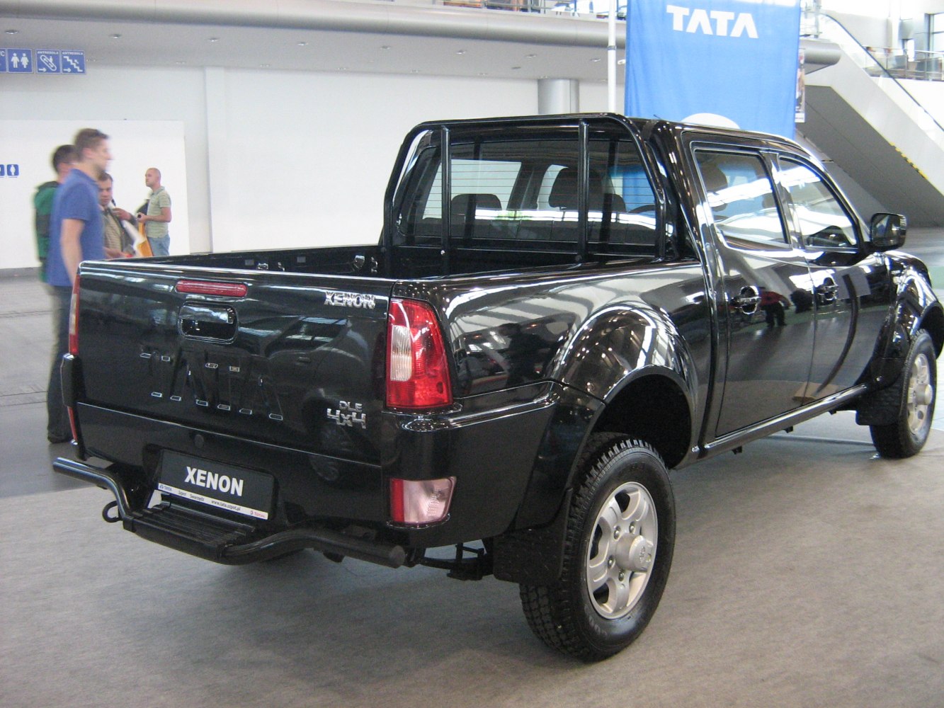 Rear view of a double cab pickup with visible cargo bed and tail lights