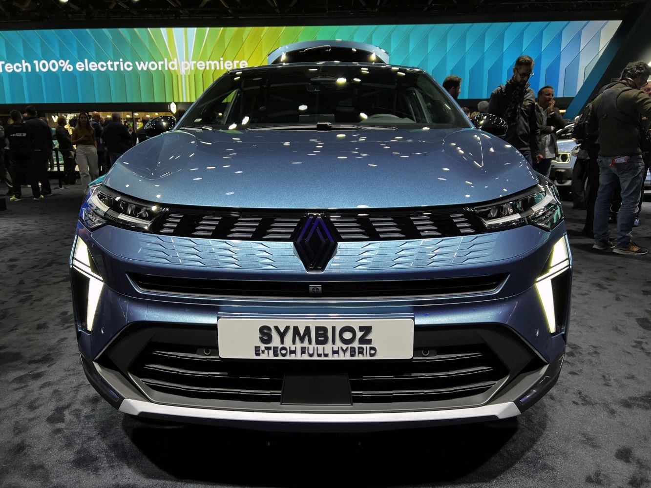 Front view of hybrid car with LED headlights and prominent grille.
