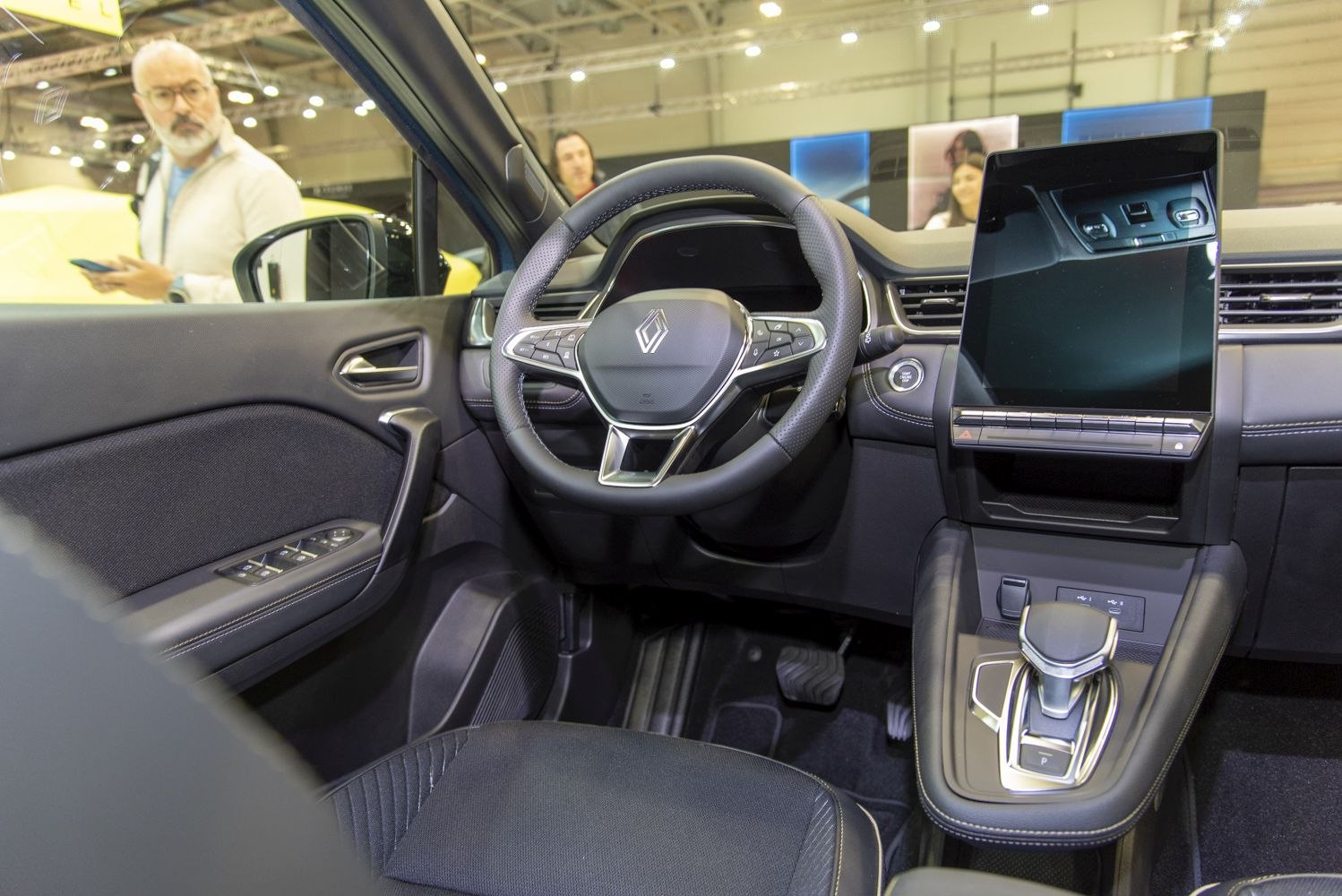 Multifunctional steering wheel and large vertical digital touchscreen display