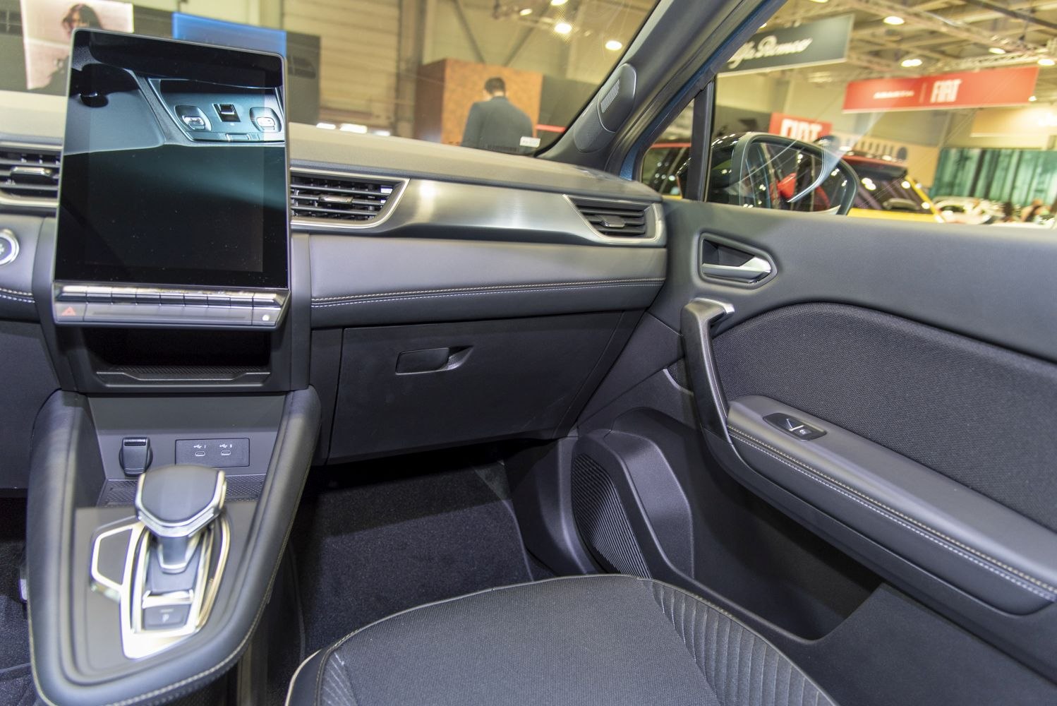 Large central touchscreen and sleek dashboard design with advanced controls