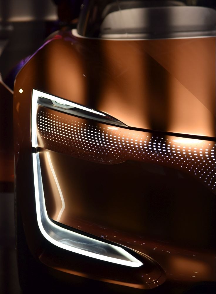 Futuristic front LED headlight with perforated light pattern.