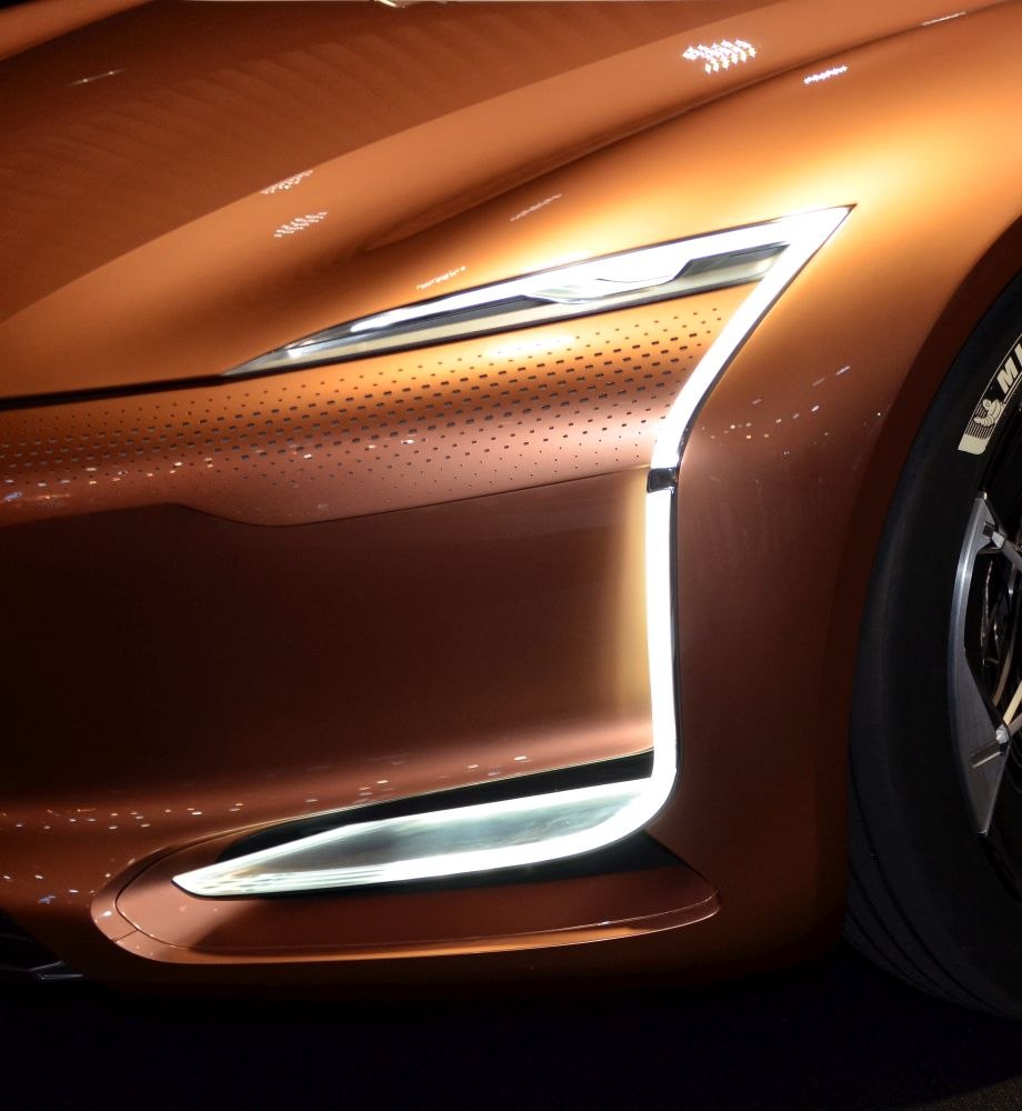 Futuristic LED headlight and sculpted front fender with illuminated accents