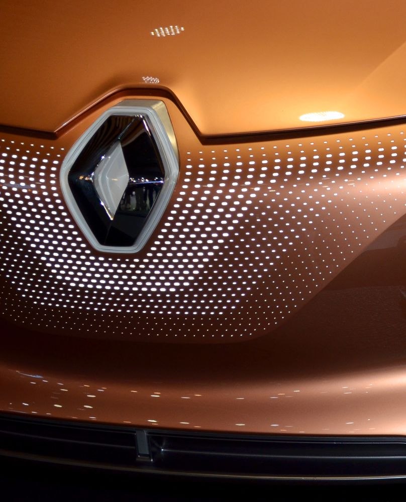 Front emblem and perforated hood design on a metallic surface