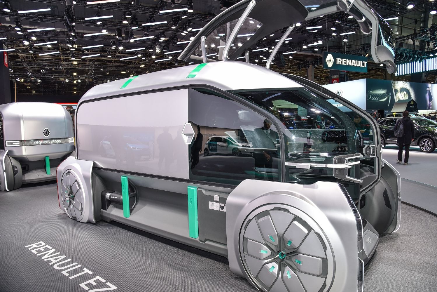Futuristic autonomous delivery vehicle with modular cargo units and unique wheel design