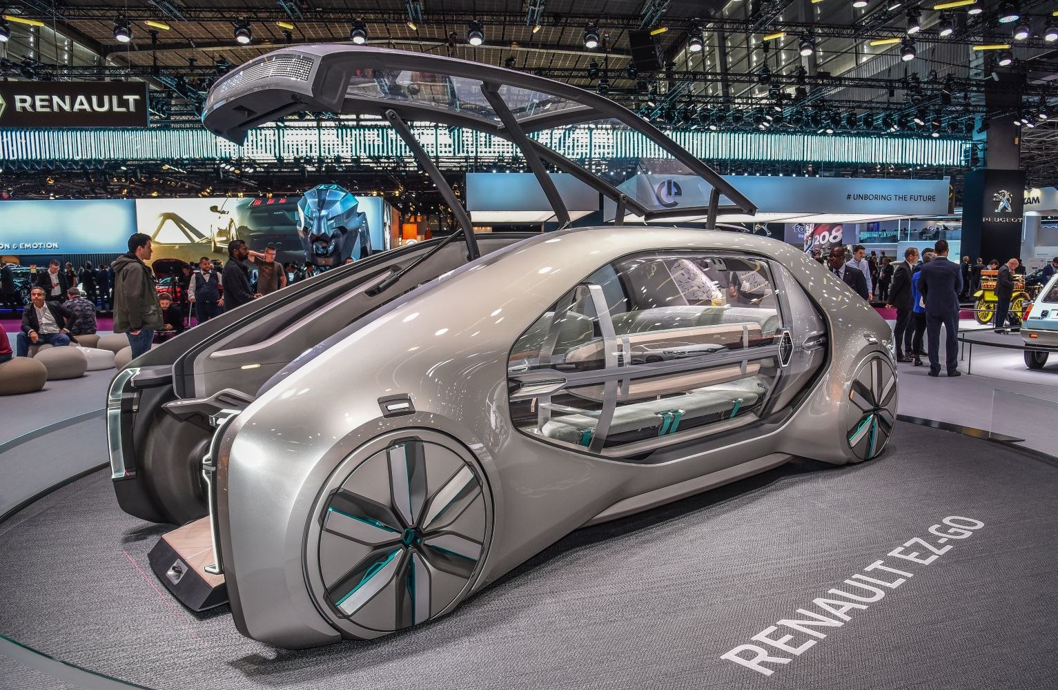 Futuristic transparent doors and large gullwing rear hatch at automotive exhibition